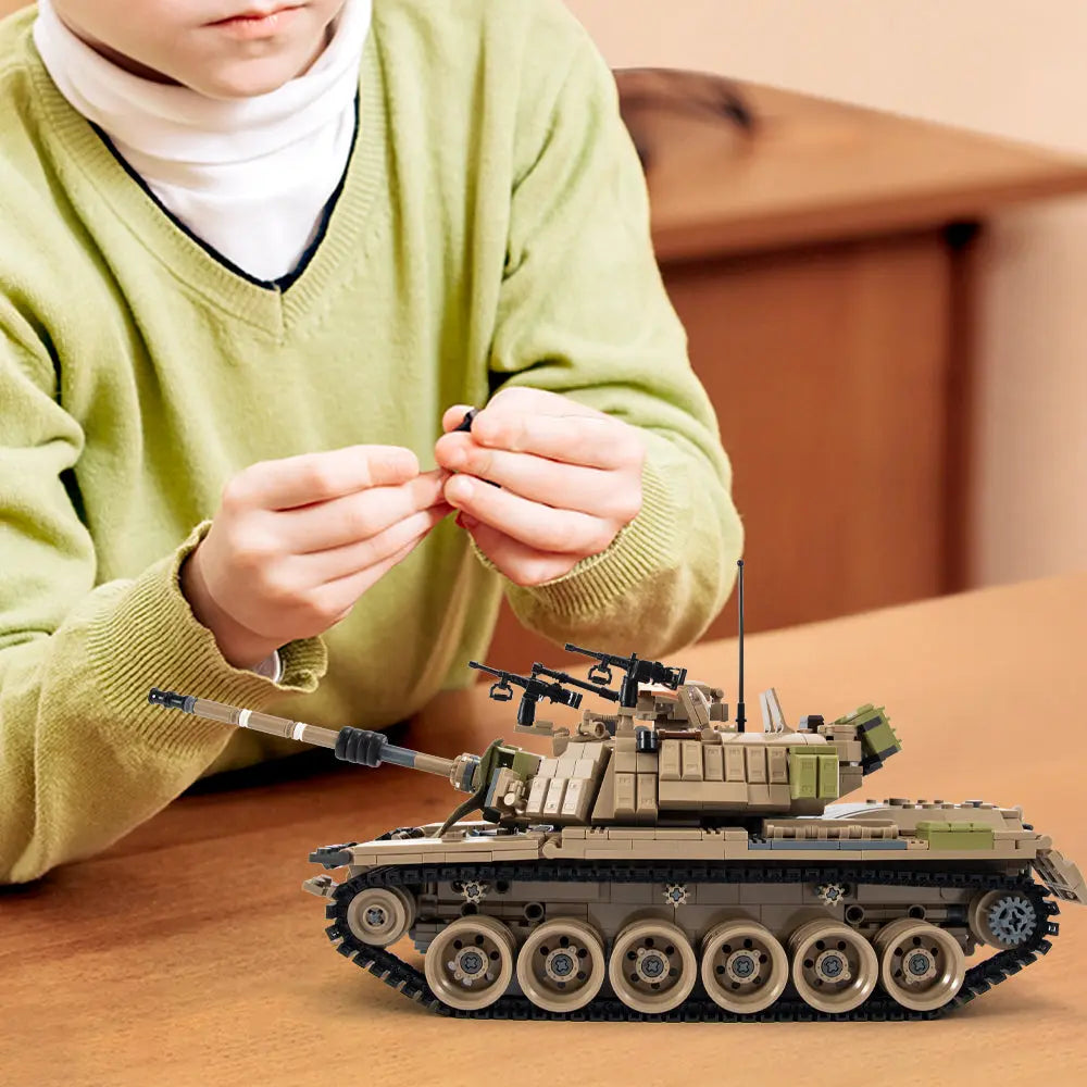 A dedicated hobbyist displaying the intricate DAHONPA military tank building blocks model at a wooden desk