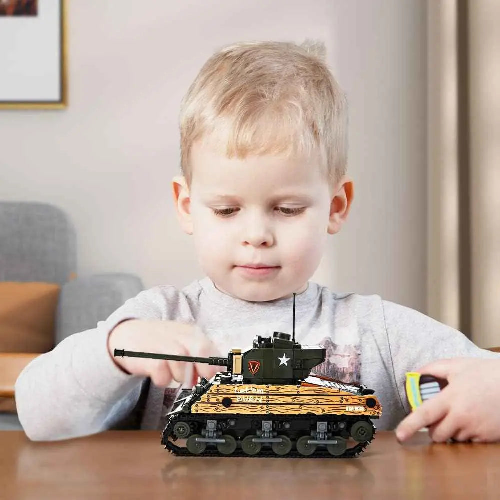 Young builder focusing on the detailed mechanical structures of the DAHONPA military tank building blocks model